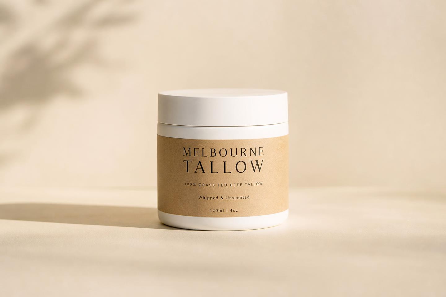 A jar of golden beef tallow on warm linen